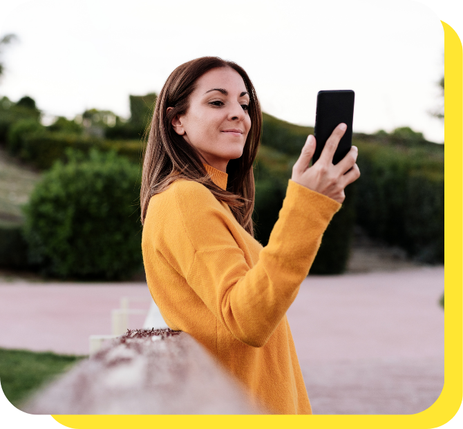 Woman happily talking on the phone, exploring serve and protect loan opportunities.