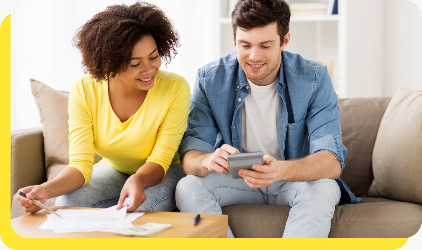 A smiling man and woman using a credit union loan calculator, highlighting the ease of planning affordable car loans with Serve and Protect.
