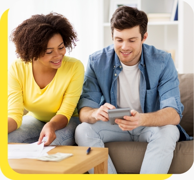 A smiling man and woman using a credit union loan calculator, highlighting the ease of planning affordable car loans with Serve and Protect.
