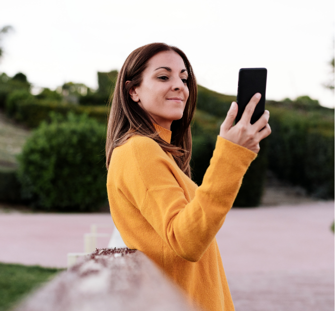 Woman happily talking on the phone, exploring serve and protect loan opportunities.