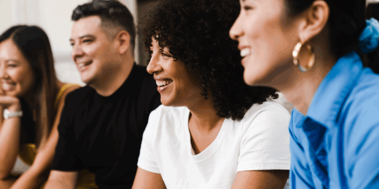 Group of four people smiling