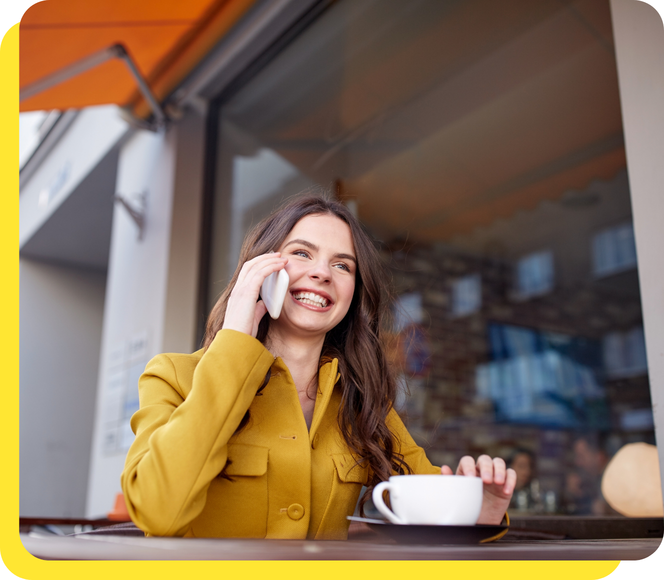 Happy woman smiling whilst calling Serve and Protect Credit Union's friendly customer support team for assistance.