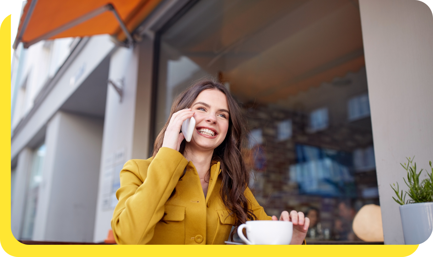 Happy woman on the phone receiving trusted support and personalised assistance with her credit union savings enquiry.