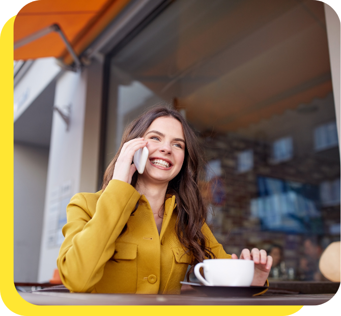 Happy woman smiling whilst calling Serve and Protect Credit Union's friendly customer support team for assistance.