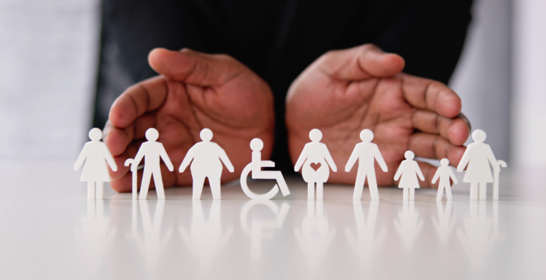 Hands protecting a diverse range of people to represent financial inclusion