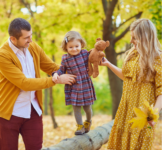 Happy family of three smiling together, representing financial security and trust as credit union members