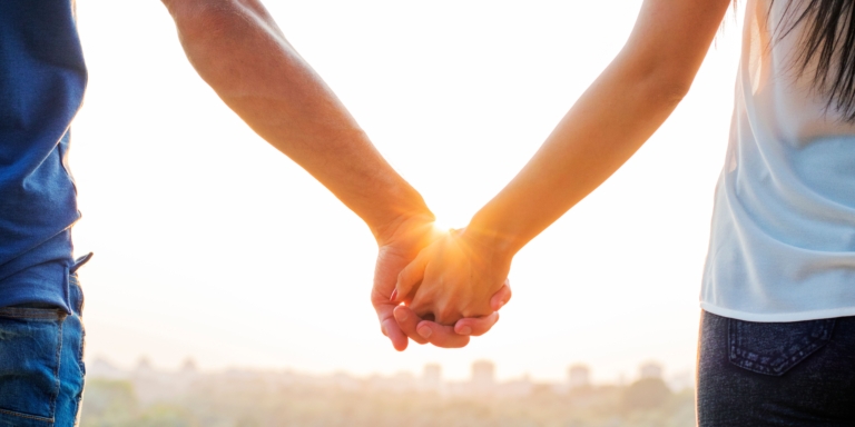 Couple holding hands, symbolising togetherness in the face of debt